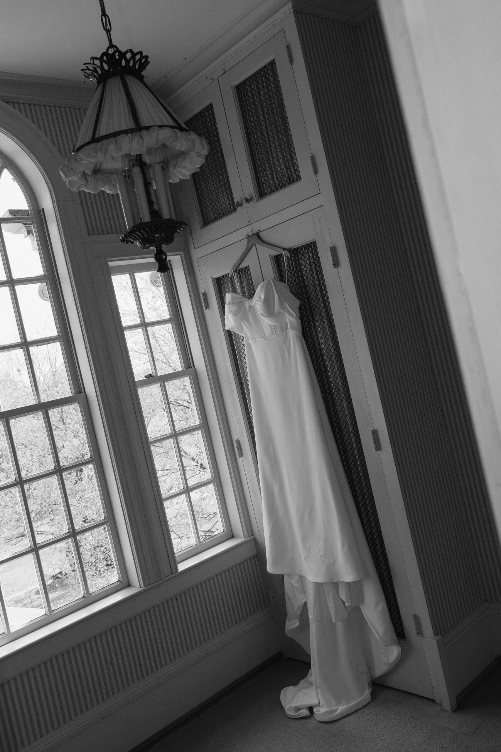 A romantic wedding dress hung in the bridal suite.